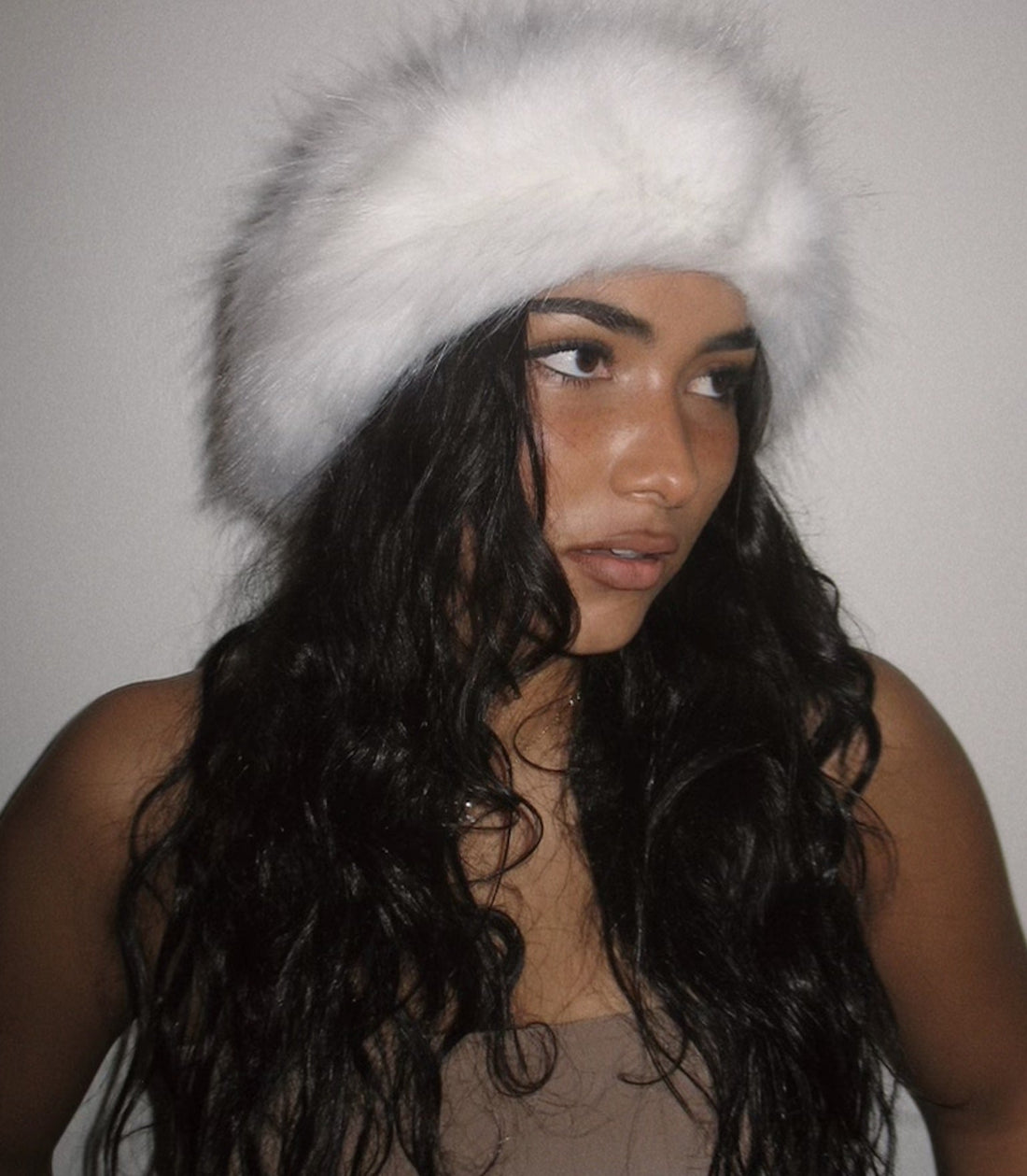 Sienna Mae Gomez wears fluffy white hat