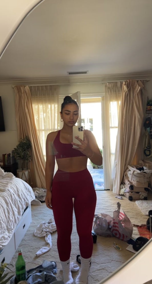 Sienna Mae Gomez poses in messy room in matching burgundy set