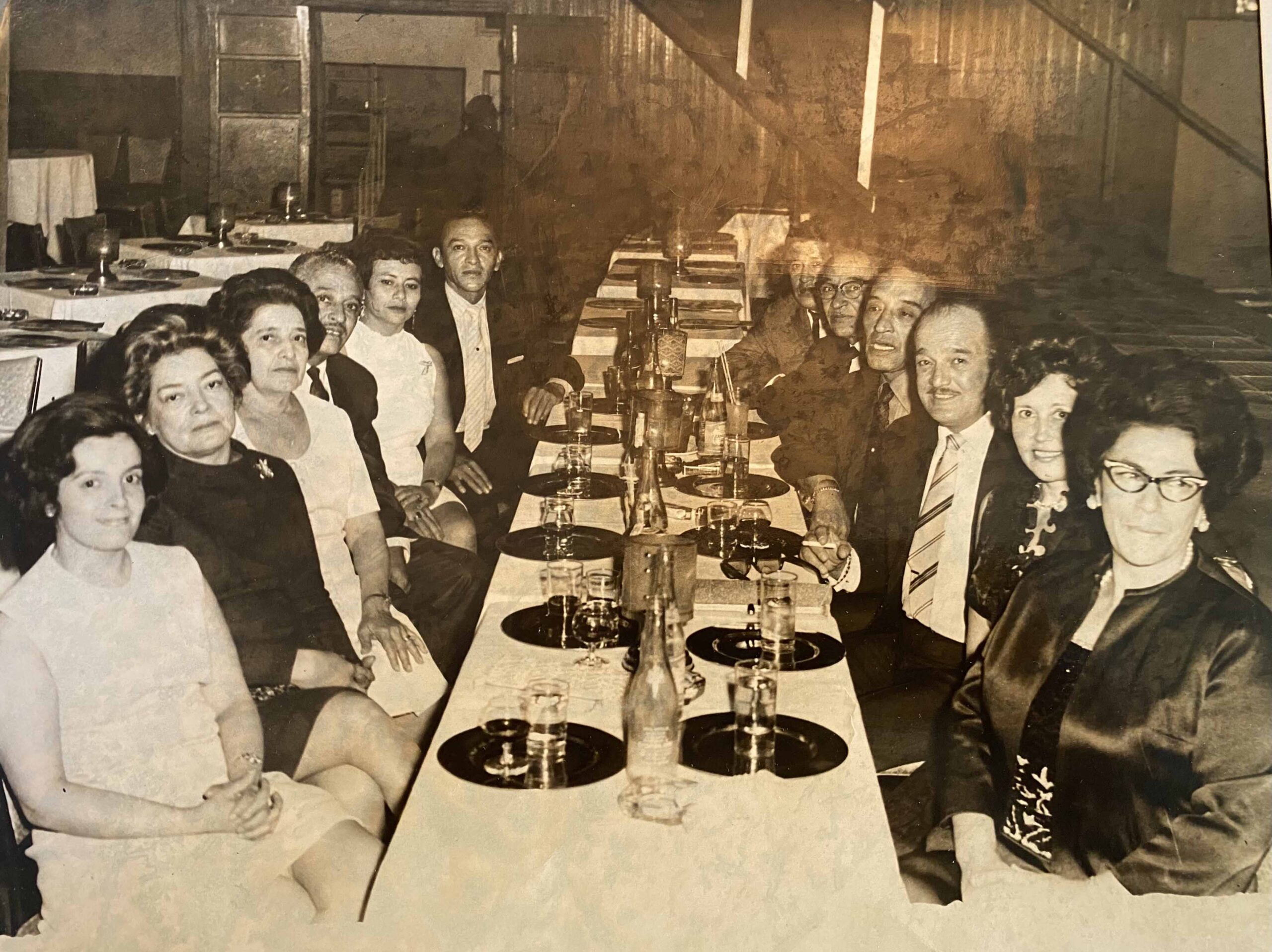 Old photo of people sitting at a table