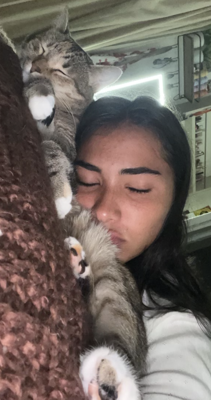 Sienna Mae Gomez cuddling cat