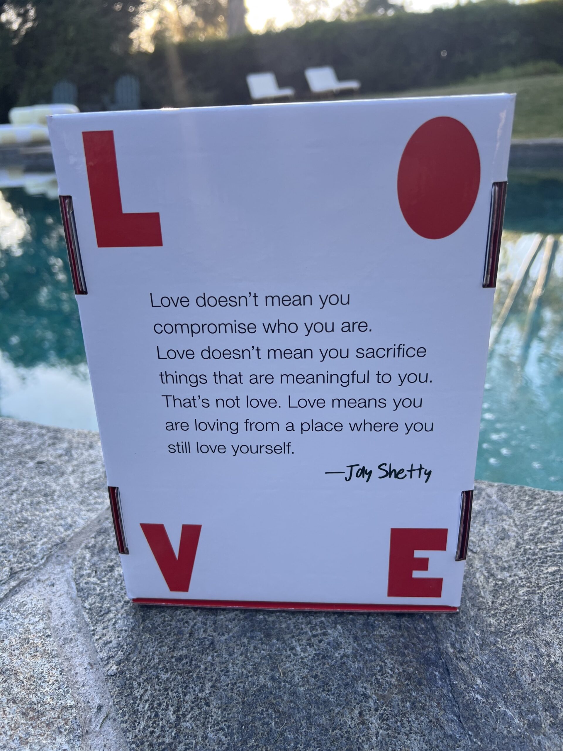 Poolside photo of Jay Shetty's 8 Rules of Love box