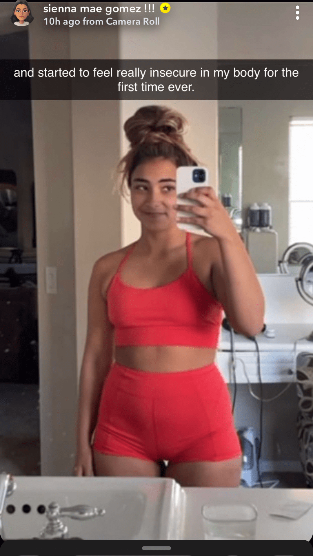 Sienna Mae poses in red two piece workout set; girl in mirror selfie taking photo wearing red two piece workout set