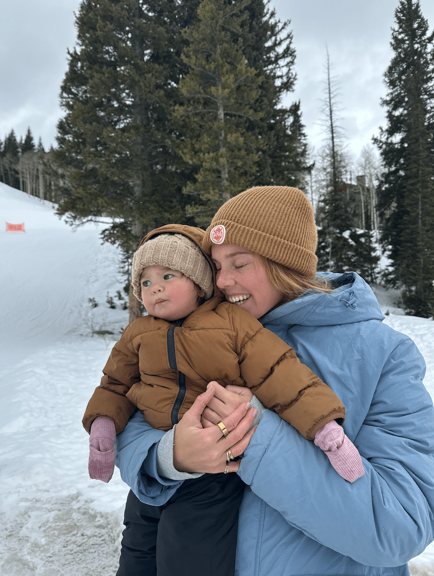 woman holding baby in snow